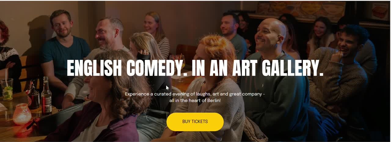 Audience enjoying a comedy show in an art gallery